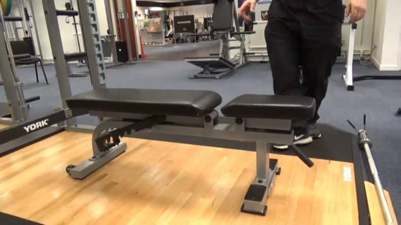 adjustable weight bench in commercial gym on wooden flooring