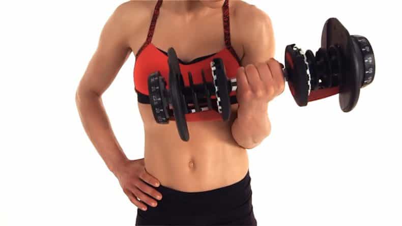Woman bicep curling with bowflex 552 dumbbell