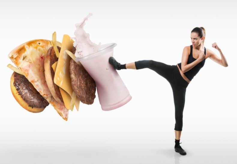 woman kicking unhealthy burger