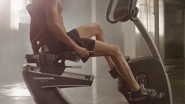 man on recumbent bike home gym man exercising on recumbent exercise bike
