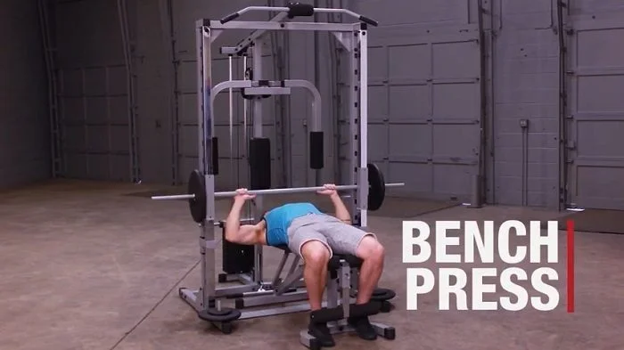 man performing bench press on Powerline smith machine
