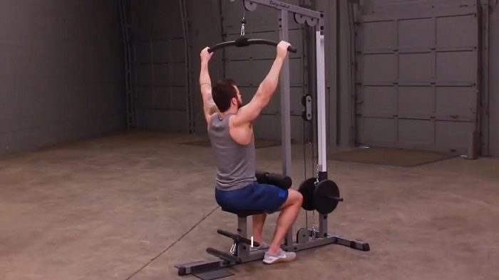 man performing lat pulldowns on body-solid lat pulldown machine