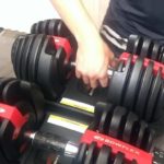 man holding one of two bowflex dumbbells 552
