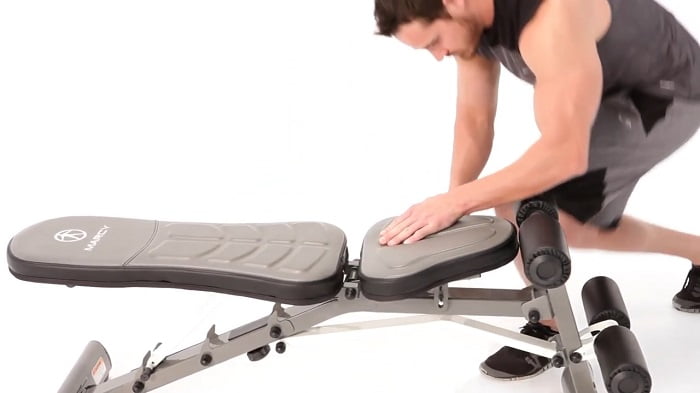 man adjusting marcy weight bench seat