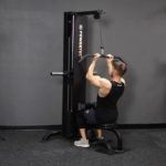 young man performing lat pulls on powertec lat pulldown machine