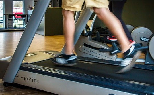 man running on a treadmill in a gym