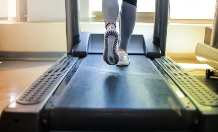 treadmill workout woman running on treadmill at home