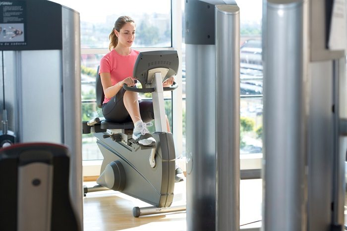 woman exercising on her recumbent bike indoors