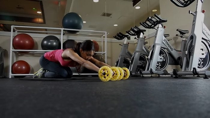 SKLZ COREwheels - Dynamic Core Strength Trainer woman performing roll outs with SKLZ core wheels