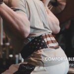 man performing squats wearing fire team fit weight lifting belt