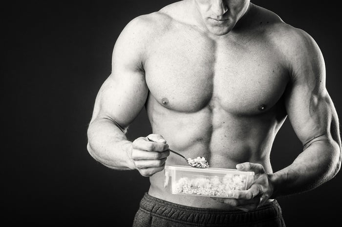 muscly man eating fit man eating food the best supplement for muscle growth