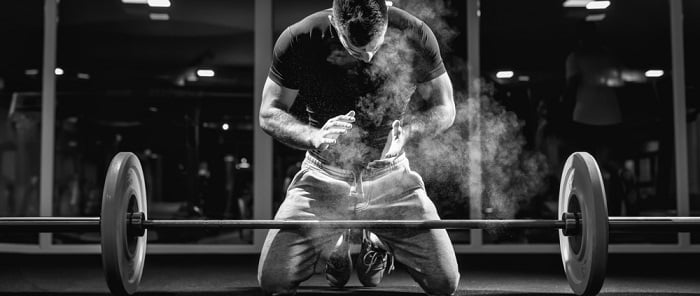 weight lifter man preparing to lift a weight to improve his workout