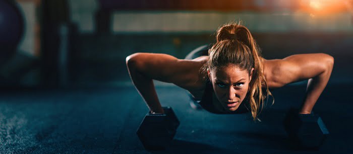 woman exercising with dumbbells woman doing one set workout with dumbbells