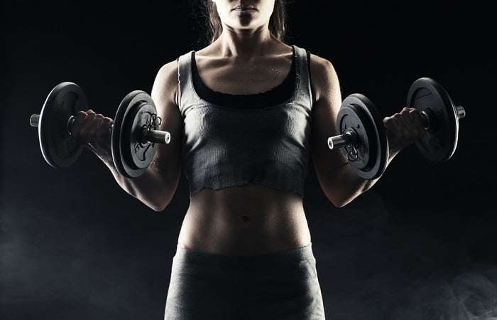 woman with dumbbells young woman holding dumbbells