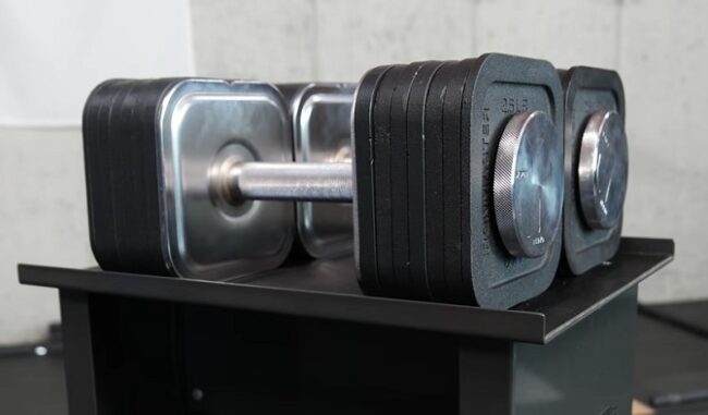 Adjustable Dumbbells - Ironmaster 75lb Pair of ironmaster 75lb dumbbells on stand