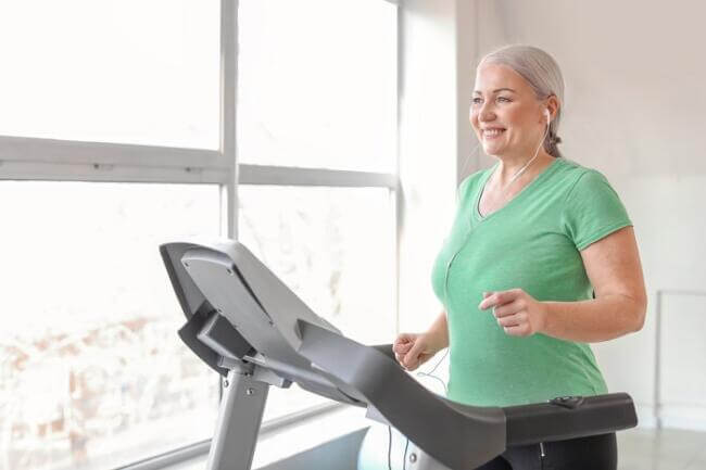 senior woman treadmill senior woman exercising on her treadmill at home