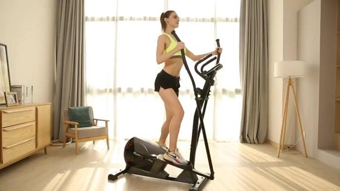 woman exercising on snode e16 elliptical in her front room