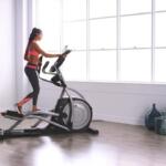 woman exercising on her quiet elliptical in her apartment