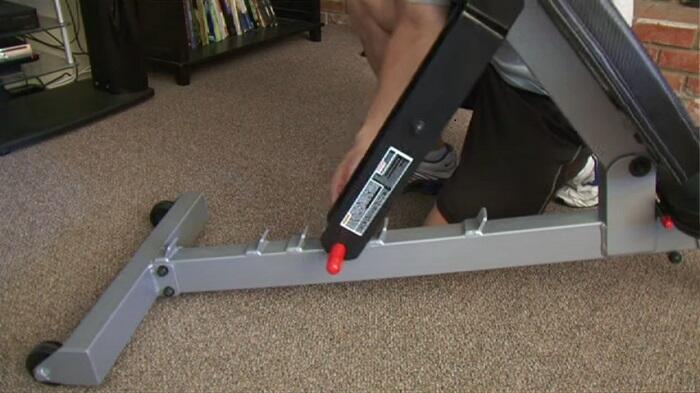 PowerBlock Sport Bench back pad man adjusting powerblock sports bench back pad