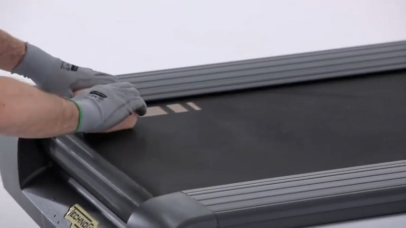 How to clean your Technogym treadmill wiping man cleaning his treadmill