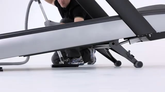 How to clean your treadmill vacuum man vacuuming his treadmill