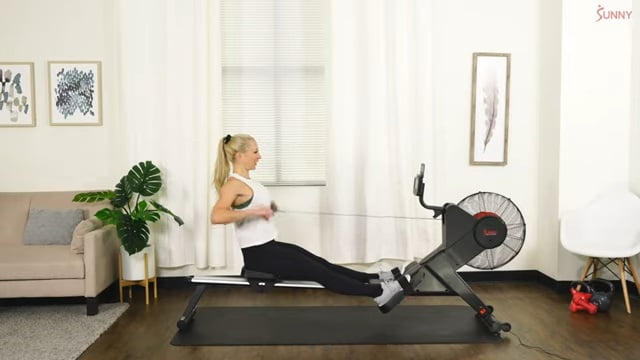 woman rowing on sunny rowing in home gym indoor rowing on sunny health air rower
