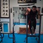 man performing dips on xmark dip station in this home gym