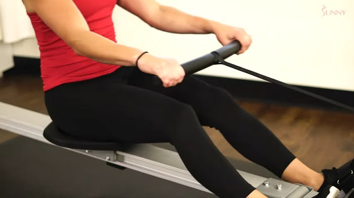 woman rowing fast on budget rowing machine