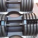 set of two profrom dumbbells in back yard of house