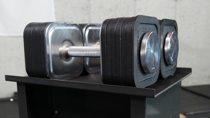 ironmaster adjustbale dumbbells 75lb pair of ironmaster adjustable 75lb dumbbels on stand