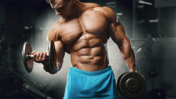 bodybuilder performing dumbbell curls man performing two arm dumbbell curls