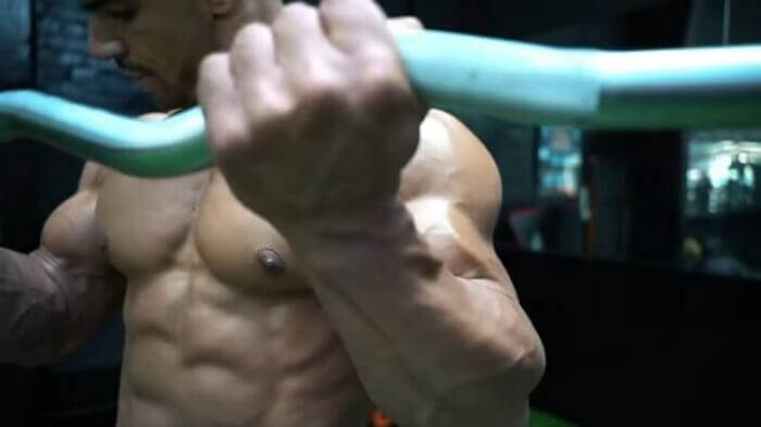 minerals for muscle growth man performing EZ bar curls