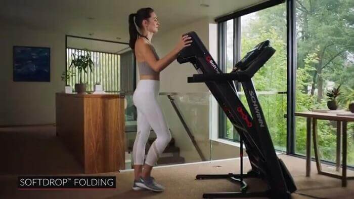 woman folding Schwinn treadmill