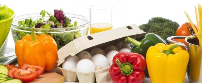carton of 10 eggs surrounded with vegetables
