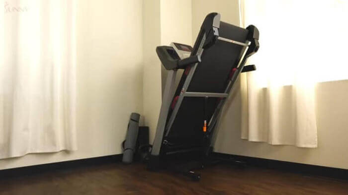 sunny health 7 fitness sf-t7917 treadmill folded in corner of the room