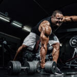 man performing heavy dumbbell rows