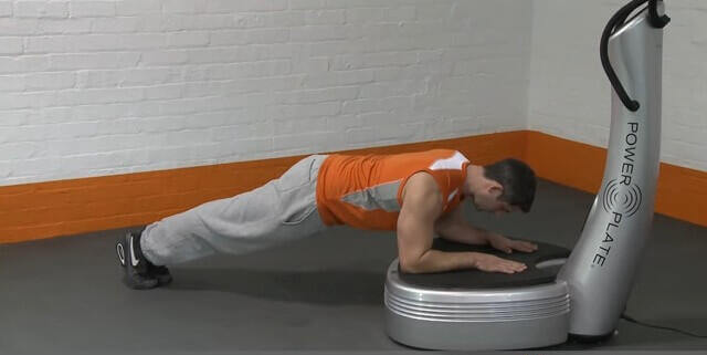 Power Plate Plank man performing plank exercise on vibration plate