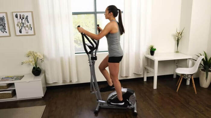 Sunny Health & Fitness SF-E905 Magnetic Elliptical woman pedaling on sunny sf-e905 elliptical
