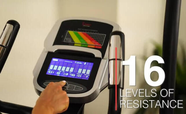 sunny health elliptical monitor woman selecting resistance level on elliptical monitor