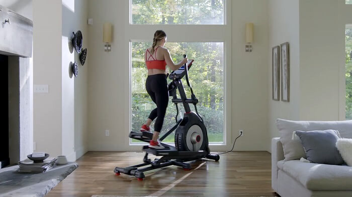 Schwinn 470 Elliptical side view side view of woman pedaling schwinn 470 elliptical