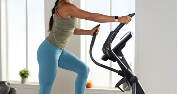 incline elliptical workout woman performing incline workout on proform carbon el elliptical