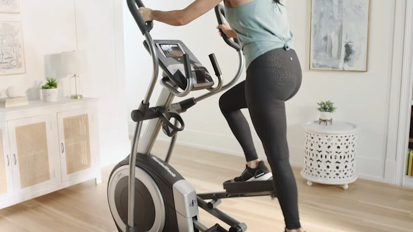 woman at home on her 9.9 elliptical woman pedaling on 20" stride elliptical