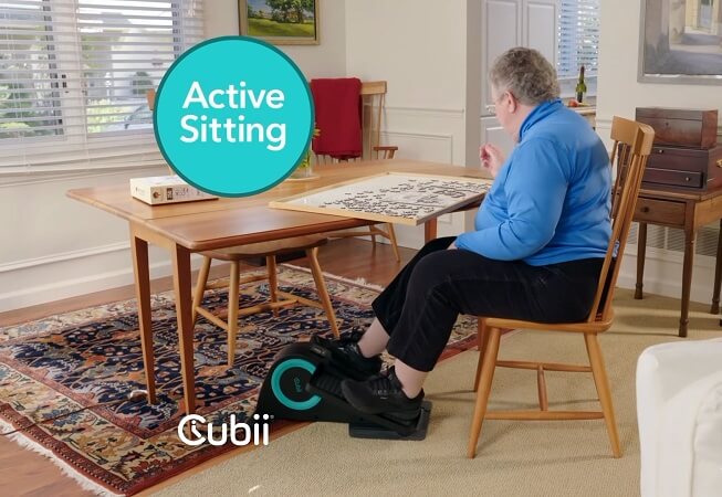senior woman exercising using cubii desk elliptical
