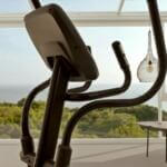 elliptical in bay window with sea in backgorund