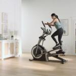 woman pedaling an elliptical with power incline
