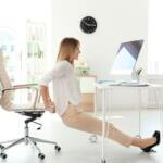 woman performing tricep dips at her desk