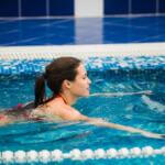 attractive woman swimming in Olympic ppol