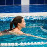 attractive woman swimming in Olympic ppol