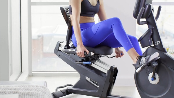 woman pedaling on r618 recumbent bike