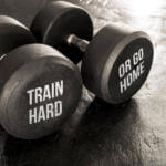 a pair of dumbbells with motivational quotes written on them
